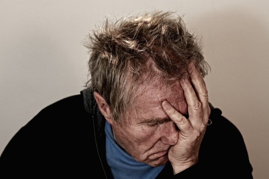 man holding his face